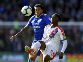 Cardiff City's Nathaniel Mendez-Laing, left, and Crystal Palace's Aaron Wan-Bissaka battle for the ball during their English Premier League soccer match at Cardiff City Stadium, Cardiff, Wales, Saturday May 4, 2019.