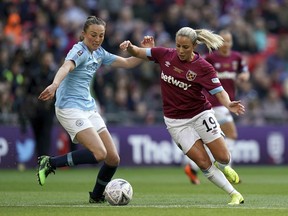 Manchester City's Caroline Weir, left, and West Ham's Adriana Leon battle for the ball during the Women's FA Cup Final at Wembley Stadium, London, Saturday May 4, 2019.