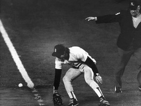 FILE - In this Oct. 25, 1986, file photo, Boston Red Sox first baseman Bill Buckner misplays the ball during during Game 6 of the World Series against the New York Mets. Buckner, a star hitter who became known for making one of the most infamous plays in major league history, has died. He was 69. Buckner's family said in a statement that he died Monday, May 27, 2019, after a long battle with dementia.