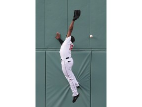 Boston Red Sox's Jackie Bradley Jr. misses the ball on a triple by Houston Astros' George Springer during the first inning of a baseball game in Boston, Saturday, May 18, 2019.