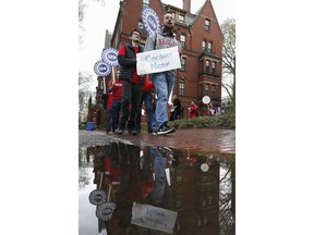 Union protesters march at Harvard University in Cambridge, Mass., Wednesday, May 1, 2019. Students plan campus-wide protests on Wednesday over what organizers say are increasing incidents of harassment and discrimination.