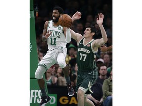 Boston Celtics' Kyrie Irving (11) passes the ball in front of Milwaukee Bucks' Ersan Ilyasova (77) during the first half of Game 4 of a second-round NBA basketball playoff series in Boston, Monday, May 6, 2019.