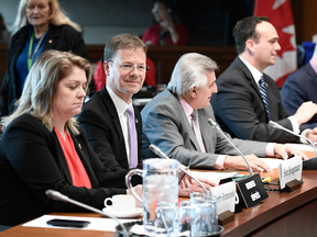 Liberal MPs Sherry Romanado, Sven Spengemann, Yves Robillard and Mark Gerretsen wait for the start of the Standing Committee on National Defence, Sherry on Parliament Hill in Ottawa on May 16, 2019.