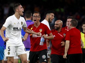 Valencia defender Gabriel Paulista, left, reacts as he celebrates his team's second goal during the Copa del Rey soccer match final between Valencia CF and FC Barcelona at the Benito Villamarin stadium in Seville, Spain, Saturday. 25, 2019.