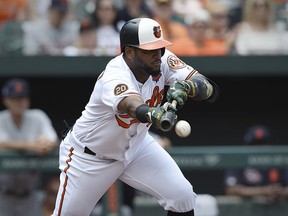 Baltimore Orioles' Hanser Alberto bunts for a base hit against the Detroit Tigers in the first inning of a baseball game Monday, May 27, 2019, in Baltimore, Md.