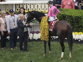 CORRECTS TO MARK CASSE INSTEAD OF GARY BARBER - Jockey Tyler Gaffalione sits aboard War of Will as trainer Mark Casse holds the reins after winning the Preakness Stakes horse race at Pimlico Race Course, Saturday, May 18, 2019, in Baltimore.
