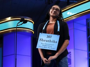 Shruthika Padhy, 13, of Cherry Hill, N.J., reacts after correctly spelling a word in the third round of the Scripps National Spelling Bee, Wednesday, May 29, 2019, in Oxon Hill, Md.