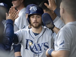 Tampa Bay Rays' Brandon Lowe celebrates with teammates in the dugout after scoring during the first inning of the team's baseball game against the Baltimore Orioles, Friday, May 3, 2019, in Baltimore.