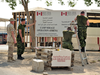 Warrant Officer Ed Storey, left, and other members of the Mission Closure Team remove the Camp Mirage entrance sign on Oct. 19, 2010.