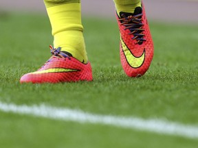 FILE - In this Sept. 13, 2014, photo a view of rainbow laces in Tottenham Hotspurs' Harry Kane boots, as part of an anti-homophobia campaign, as he warms up ahead of their English Premier League soccer match against Sunderland at the Stadium of Light, Sunderland, England. The French football league has set up an action plan to tackle homophobia in its stadiums that paves the way for judicial sanctions against abusive fans.