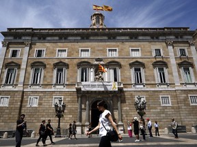 A banner reading in Catalan: "Freedom political and exiled prisoners" hangs from the balcony of the Palau Generalitat, in Sant Jaume square in Barcelona, Spain, Monday, May 27, 2019. The lower chamber of Spain's Parliament on Friday suspended Oriol Junqueras and three colleagues from their recently gained seats as national lawmakers because they are currently in jail during an ongoing trial at Spain's Supreme Court. They face up to 25 years in prison for rebellion charges that stem from a banned referendum and an independence declaration made by the separatist-controlled Catalan government in late 2017.