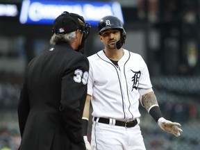 Detroit Tigers' Nicholas Castellanos, right, talks with home plate umpire Paul Nauert after striking out against the Miami Marlins during the first inning of a baseball game in Detroit, Tuesday, May 21, 2019.