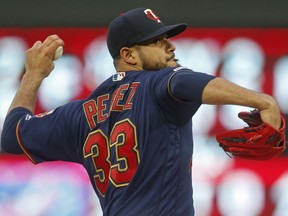 Minnesota Twins' pitcher Martin Perez throws against the Houston Astros in the first inning of a baseball game Wednesday, May 1, 2019, in Minneapolis.