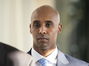 FILE - In this Friday, April 26, 2019, file photo, former Minneapolis police officer Mohamed Noor walks to court in Minneapolis. The city of Minneapolis is paying $20 million to settle a lawsuit over Noor's fatal shooting of the unarmed Justine Ruszczyk Damond, who approached his squad car after calling 911 to report a possible crime. Mayor Jacob Frey announced the settlement Friday, three days after a jury convicted Noor of murder and manslaughter in the 2017 death of Damond. Frey called the settlement "a way for our city to move forward."