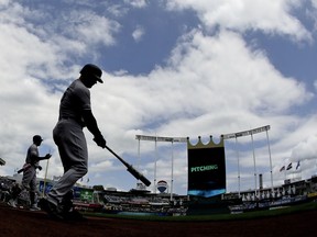 New York Yankees' Luke Voit, second from left, and Aaron Hicks warm up before batting in the first inning of the first baseball game in a double header against the Kansas City Royals, Saturday, May 25, 2019, in Kansas City, Mo.