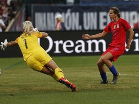 United States forward Tobin Heath, right, scores past New Zealand goalkeeper Erin Nayler during the first half of an international friendly soccer match Thursday, May 16, 2019, in St. Louis.