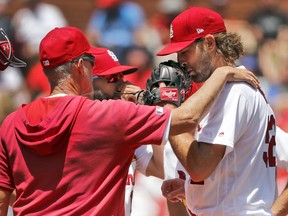 St. Louis Cardinals pitching coach Mike Maddux, left, talks with starting pitcher Michael Wacha during the third inning in the first game of a baseball doubleheader against the Kansas City Royals Wednesday, May 22, 2019, in St. Louis.