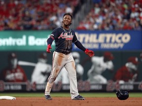 Atlanta Braves' Ozzie Albies smiles after hitting an RBI-double during the seventh inning of a baseball game against the St. Louis Cardinals, Saturday, May 25, 2019, in St. Louis.