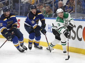 Dallas Stars defenseman John Klingberg (3), of Sweden, moves the puck ahead of St. Louis Blues' Tyler Bozak (21) and Robert Thomas (18) during the second period in Game 5 of an NHL second-round hockey playoff series Friday, May 3, 2019, in St. Louis.