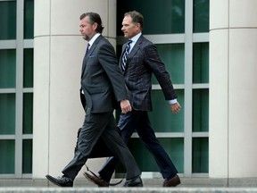In this Friday, May 10, 2019 photo, businessman John Rallo, right, and his lawyer John Rogers leave federal court in St. Louis after Rallo pleaded not guilty to three counts of honest services mail fraud/bribery.