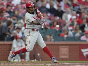 Philadelphia Phillies' Maikel Franco hits a grounder that drove in a run during the second inning of a baseball game against the St. Louis Cardinals, Tuesday, May 7, 2019, in St. Louis. Franco reached on a fielder's choice.