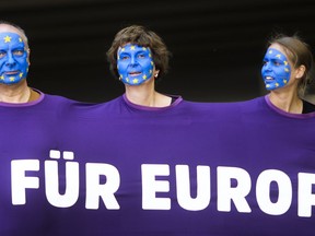 People, with faces painted like a European flag, arrive for a demonstration in Berlin, Germany, Sunday, May 19, 2019. People across Europe attend demonstrations under the slogan 'A Europe for All - Your Voice Against Nationalism'. The banner reads 'For Europe".