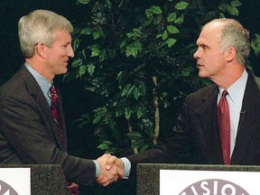FILE  - This is an October 1999 file photo then Mississippi Lt. Gov. Ronnie Musgrove, left, and former 4th District Congressman Mike Parker shake hands at a televised debate in Jackson, Miss. A federal lawsuit being filed Thursday, May 30, 2019, seeks an injunction in this year's elections against using what it describes as a "racist electoral scheme" that "intentionally and effectively dilutes African American voting strength." To win elections in Mississippi, candidates for statewide offices must receive a majority of the popular vote and win at least 62 of the 122 state House of Representatives districts. If no candidate fulfills both requirements, a statewide election is decided by the Mississippi House, as it happened in 1999, when Musgrove was elected governor.