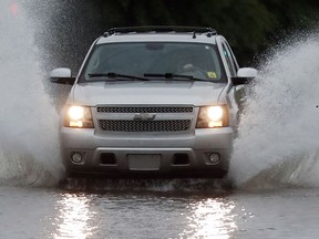 A vehicle drives through floodwaters in downtown Jackson, Miss., Thursday, May 9, 2019, as strong winds, tornado warnings and substantial rains added to the flash flooding throughout Mississippi.