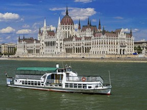 This undated photo of a boat called "Hableany" in River Danube with the Parliament building in the background in Budapest. A boat capsized and sunk in the Danube River Wednesday evening, May 29, 2019, in Budapest, with dozens of people on board, including passengers and crew, Hungarian media reported.