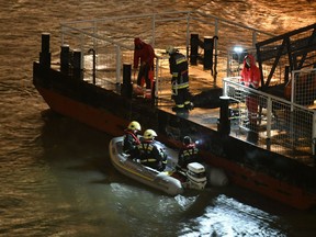 Responders sit in a rubber dinghy preparing for the search of victims next to a landing dock after a tourist boat crashed with another ship late Wednesday, May 29, 2019. The boat capsized and sunk in the Danube River Wednesday evening, May 29, 2019, in Budapest, with dozens of people on board, including passengers and crew, Hungarian media reported.
