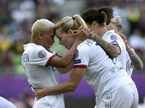 CORRECTS PHOTOGRAPHERS NAME -- Ada Hegerberg of Lyon, front right, celebrates her goal with teammate Shanice van de Sanden, left,  during the women's soccer UEFA Champions League final match between Olympique Lyon and FC Barcelona at the Groupama Arena in Budapest, Hungary, Saturday, May 18, 2019.