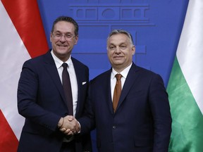 Hungarian Prime Minister Viktor Orban, right, and Austrian Vice Chancellor Heinz Christian Strache shake hands after holding a joint press conference at the PM's office in the Castle of Buda in Budapest, Hungary, Monday, May 6, 2019.