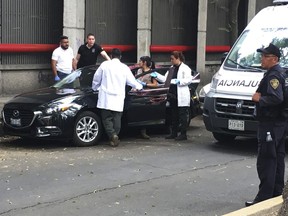 Forensic investigators examine a vehicle after the bodyguard of prominent Mexican journalist Héctor de Mauleón repelled an assault, in Mexico City, Monday, May 6, 2019. One man was killed in the attack and It was not immediately clear if de Mauleón was targeted or if it was an attempted carjacking.