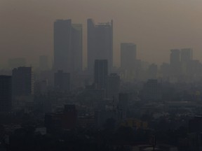 Smoke hangs over in Mexico City, Monday, May 13, 2019. Mexico City's government has warned residents to remain indoors as forest and brush fires carpeted the metropolis in a smoky haze that has alarmed even many of those accustomed to living with air pollution.