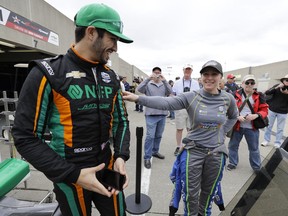 Kyle Kaiser, left, and Pippa Mann, of England, talk in the garage area before the start of practice for the Indianapolis 500 IndyCar auto race at Indianapolis Motor Speedway, Monday, May 20, 2019, in Indianapolis.