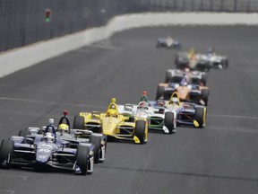 Ed Carpenter leads a group of cars into turn one during the final practice session for the Indianapolis 500 IndyCar auto race at Indianapolis Motor Speedway, Friday, May 24, 2019, in Indianapolis.
