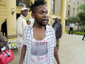 FILE - In this Friday, Feb. 22, 2019 file photo, an LGBT activist reacts after hearing that an expected high court ruling on the constitutionality of laws criminalizing same sex relationships had been postponed, in Nairobi, Kenya. Kenya's High Court is due to rule Friday, May 24, 2019 on whether laws that criminalize same sex relations are unconstitutional.