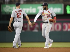 St. Louis Cardinals' Marcell Ozuna (23) celebrates with Paul DeJong (12) after the team's baseball game against the Washington Nationals, Wednesday, May 1, 2019, in Washington. The Cardinals won 5-1.