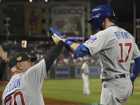 Chicago Cubs' Kris Bryant (17) celebrates his two-run home run with manager Joe Maddon (70) during the ninth inning of a baseball game against the Washington Nationals, Friday, May 17, 2019, in Washington.