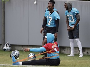 Carolina Panthers' Cam Newton stretches during the NFL football team's practice in Charlotte, N.C., Wednesday, May 22, 2019.