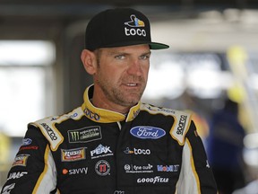 Clint Bowyer waits by his car before practice for Saturday's NASCAR All-Star Cup series auto race at Charlotte Motor Speedway in Concord, N.C., Friday, May 17, 2019.