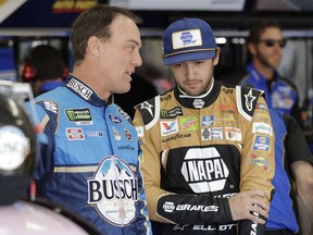 Kevin Harvick, left, talks with Chase Elliott before practice for Saturday's NASCAR All-Star Cup series auto race at Charlotte Motor Speedway in Concord, N.C., Friday, May 17, 2019.