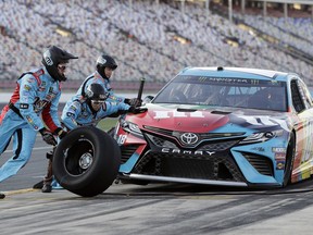 Crew members perform a pit stop on Kyle Busch's car during qualifying for Saturday's NASCAR All-Star auto race at Charlotte Motor Speedway in Concord, N.C., Friday, May 17, 2019.
