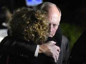 UNC Charlotte Chancellor Philip DuBois receives a hug after a news conference regarding a deadly shooting on the campus earlier in the day, Tuesday, April 30, 2019, in Charlotte, N.C.