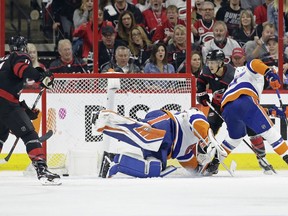 Carolina Hurricanes' Teuvo Teravainen, right, of Finland, scores against New York Islanders goalie Robin Lehner (40), of Sweden, while Islanders Anders Lee defends at right during the first period of Game 3 of an NHL hockey second-round playoff series in Raleigh, N.C., Wednesday, May 1, 2019.