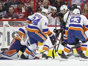 Carolina Hurricanes' Sebastian Aho scores against New York Islanders goalie Robin Lehner while Islanders' Scott Mayfield (24) and Casey Cizikas (53) defend with Adam Pelech during the first period of Game 4 of an NHL hockey second-round playoff series in Raleigh, N.C., Friday, May 3, 2019.