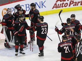 Carolina Hurricanes players celebrate following the team's win over the New York Islanders in Game 4 of an NHL hockey second-round playoff series in Raleigh, N.C., Friday, May 3, 2019.