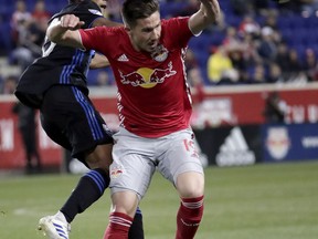 New York Red Bulls midfielder Alex Muyl, right, and Montreal Impact midfielder Shamit Shome go up for the ball during the first half of an MLS soccer match Wednesday, May 8, 2019, in Harrison, N.J.