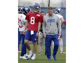 New York Giants quarterback Daniel Jones (8), who was drafted No. 6 overall, talks to head coach Pat Shurmur during NFL football rookie camp, Friday, May 3, 2019, in East Rutherford, N.J.
