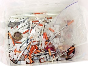This May 8, 2019, photo shows hypodermic needles, needle caps, cotton swabs and other drug paraphernalia removed from Atrisco Park, home of the Atrisco Valley Little League, in Albuquerque, N.M. The little league park is fighting a battle against discarded syringes with attached hypodermic needles amid the region's outgoing opioid epidemic.